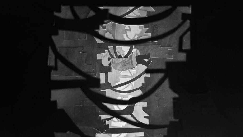 Film still featuring the main character falling down between layers of buildings.
