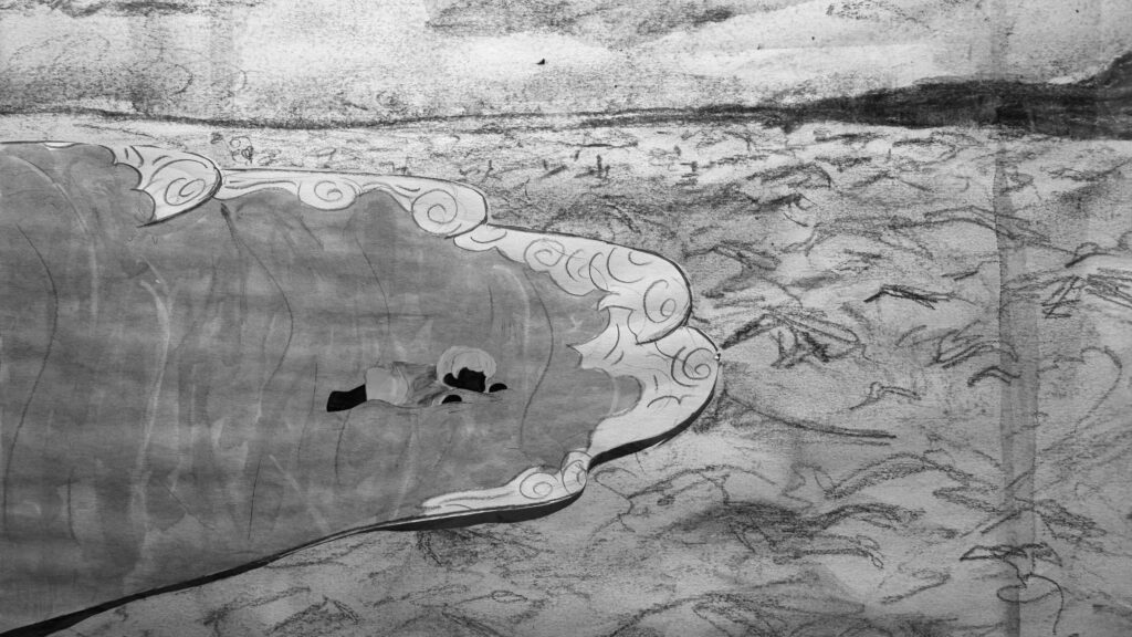 Black and white film still featuring the main character laying on the beach being washed up by the waves.