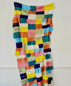 Hand stitched textile work with hand embroidered writing