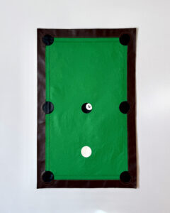 Tapestry that looks like a pool table with eight ball in the middle and white ball directly below it