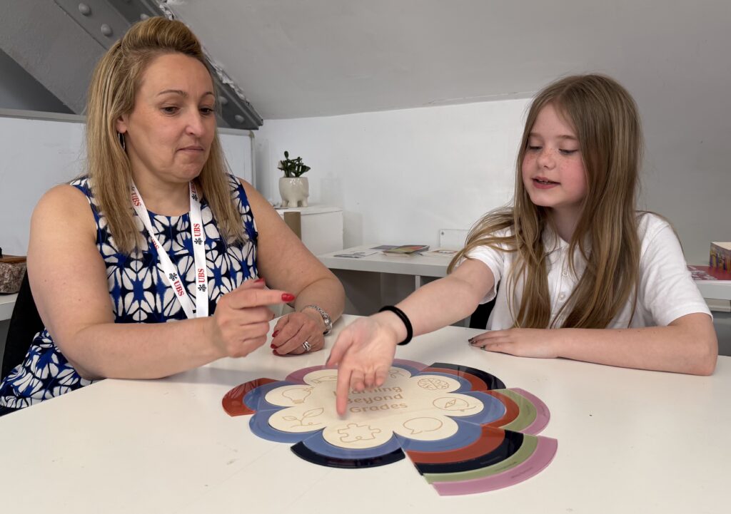 Teacher and pupil interacting with tool